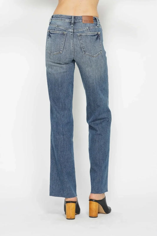 Back view of straight leg blue jeans with back pockets and brown heeled mules