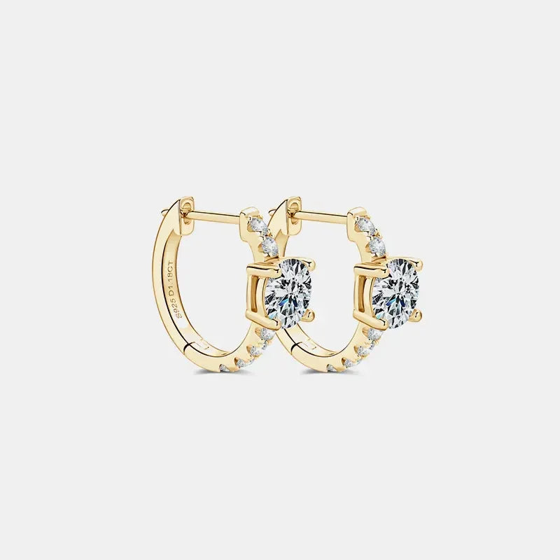 Gold hoop earrings with round clear gemstones and pavé accents on white background