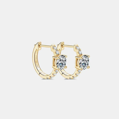 Gold hoop earrings with round clear gemstones and pavé accents on white background