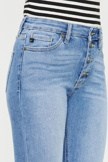 Light wash high-rise jeans with button fly and front pockets, paired with striped top.