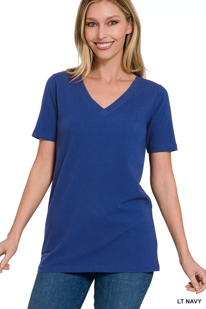Woman wearing a light navy blue V-neck short sleeve t-shirt and blue jeans