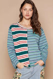 Woman wearing a relaxed fit, striped colorblock long sleeve top and casual patchwork pants.