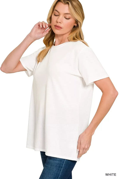 Woman wearing relaxed fit white short sleeve t-shirt and blue jeans on white background