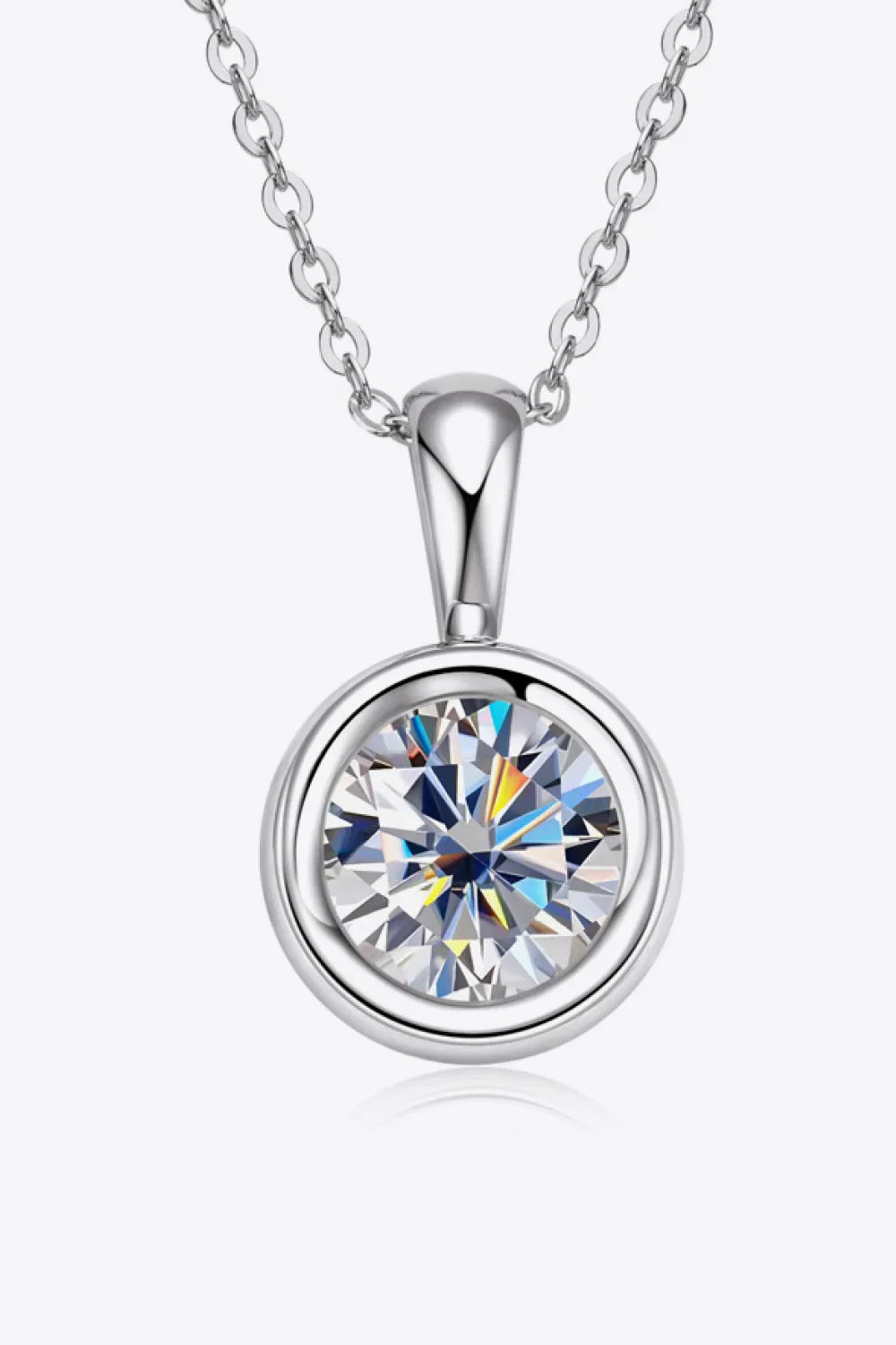 Silver chain necklace with round bezel-set clear gemstone pendant on white background