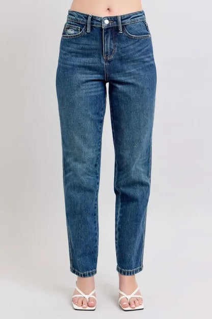 Straight leg blue denim jeans with a high waist, styled with white heeled sandals.