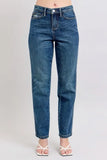 Straight leg blue denim jeans with a high waist, styled with white heeled sandals.