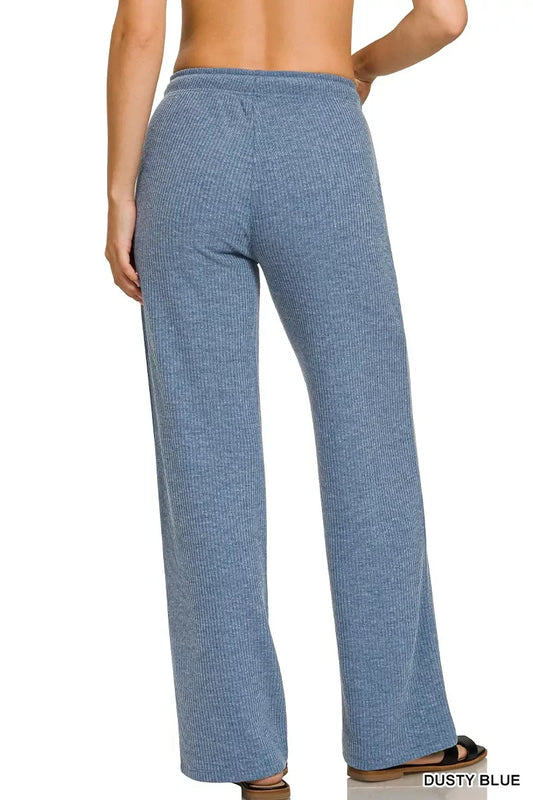 Back view of woman wearing dusty blue ribbed knit lounge pants with wide leg fit