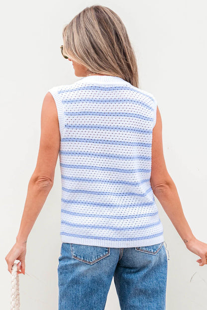 Woman in sleeveless knit striped sweater and blue jeans, holding a white woven bag
