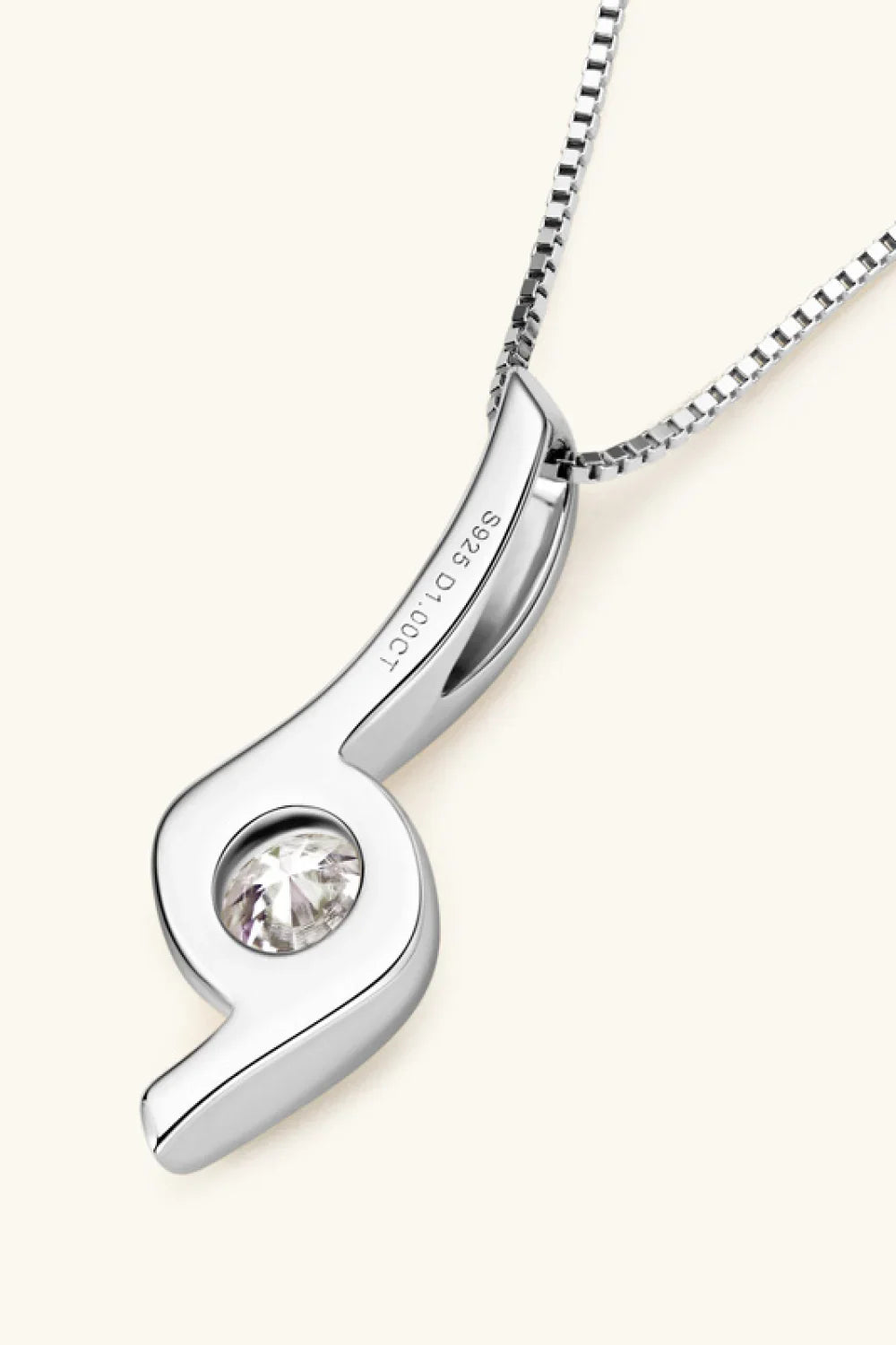Elegant sterling silver pendant necklace with round gemstone and modern, curved design.