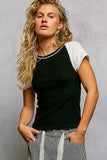 Woman wearing a black and white short sleeve knit top with striped drawstring pants