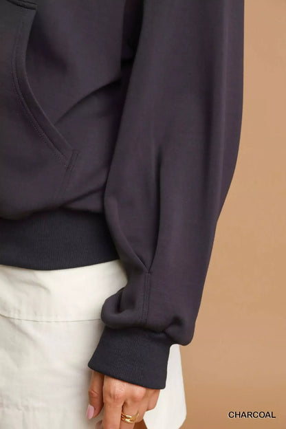 Charcoal long sleeve pullover with relaxed fit and white skirt, neutral background.