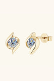 Gold stud earrings with round clear gemstones and modern leaf-inspired design on neutral background.