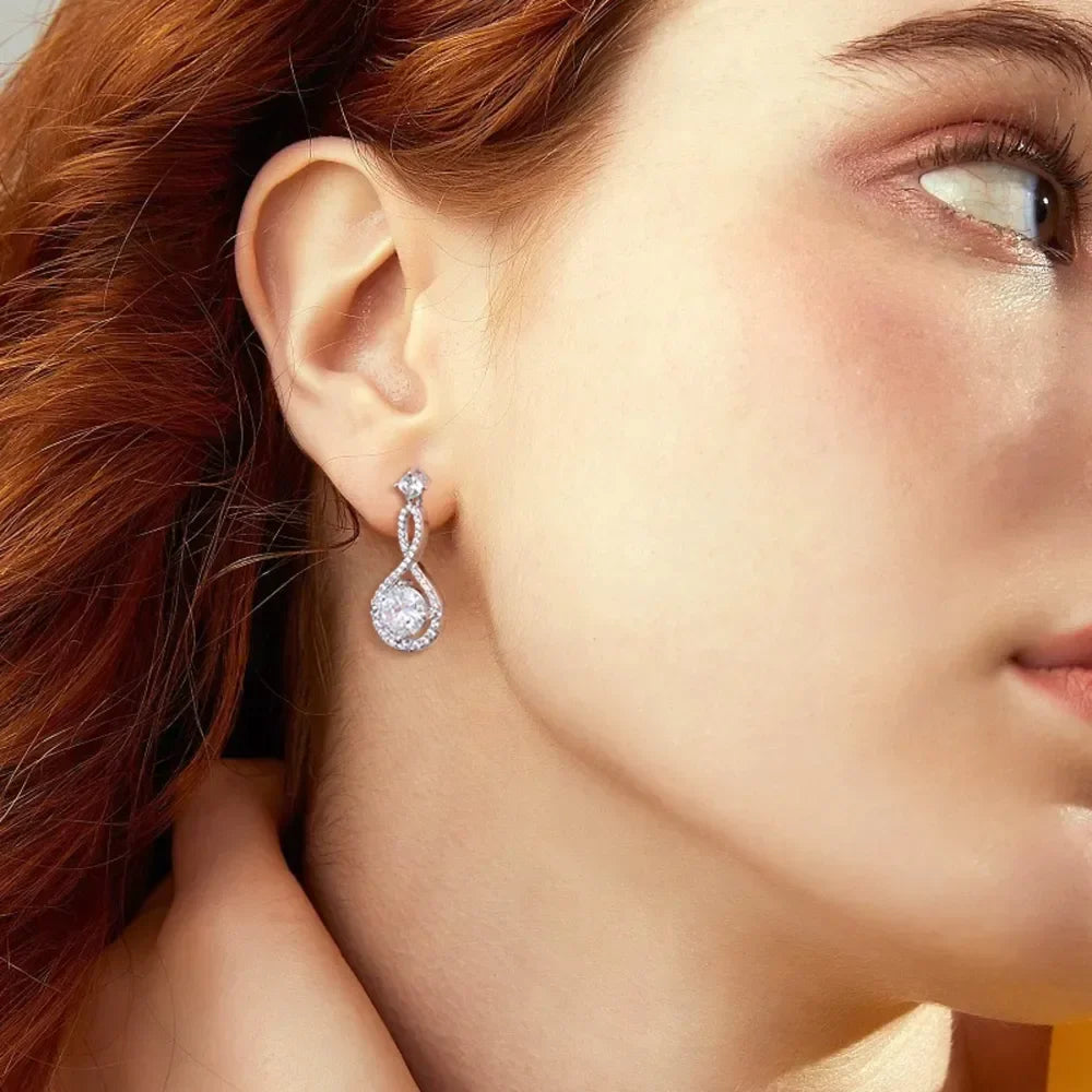 Close-up of woman wearing elegant silver teardrop crystal earrings
