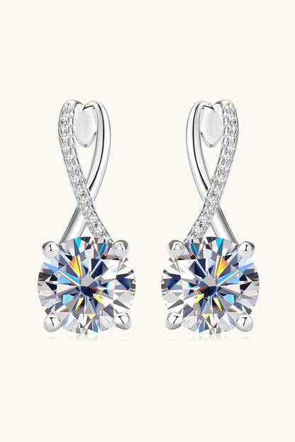 Pair of silver stud earrings with round-cut crystals and pavé accents on a neutral background.