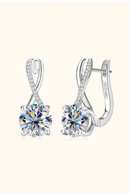 Elegant silver earrings with round-cut clear stones and pavé detailing on a light background
