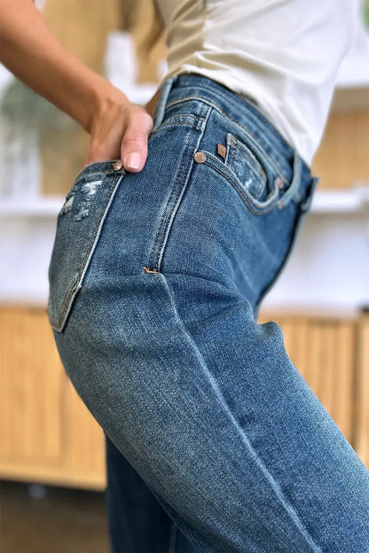 Close-up of woman wearing high-rise blue denim jeans with slight distressing