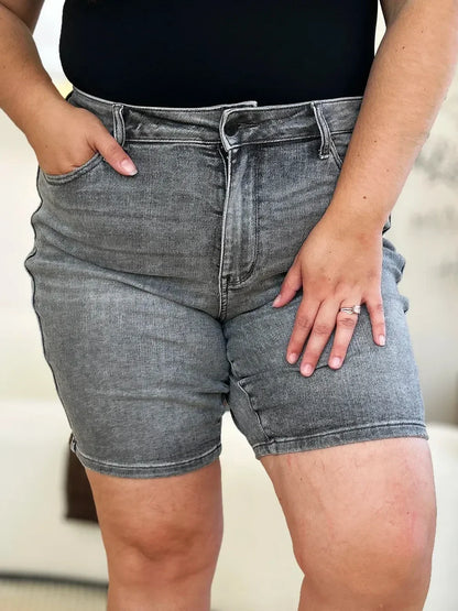 Close-up of woman wearing high-waisted gray denim shorts and black top
