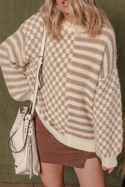 Woman wearing a cream and beige checkered knit sweater with brown skirt and cream bag