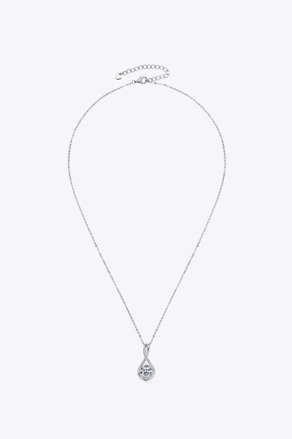Silver chain necklace with round teardrop pendant featuring a clear gemstone on white background.