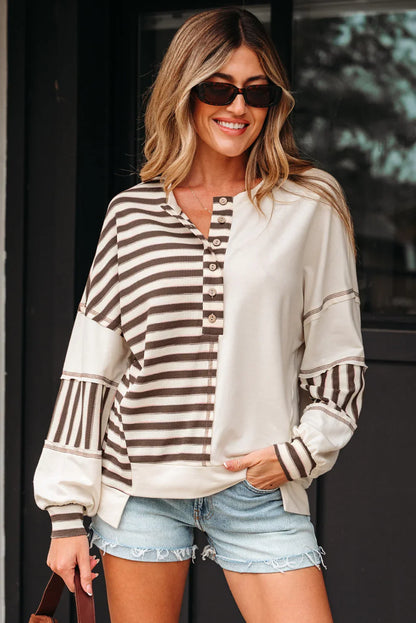 Woman in striped button-front pullover, denim shorts, and sunglasses, casual style