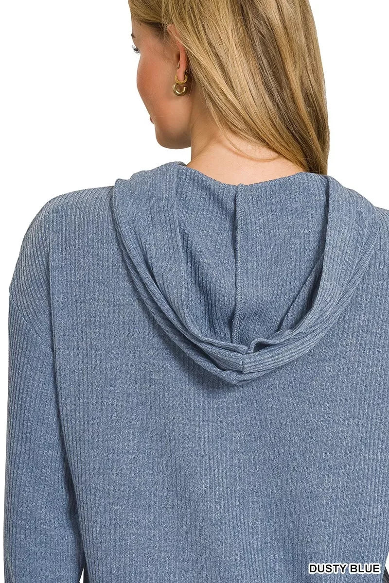 Back view of woman in ribbed dusty blue hooded sweater, casual modern style