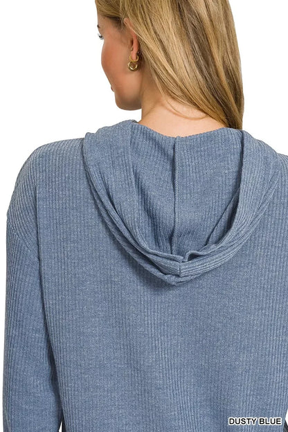 Back view of woman in ribbed dusty blue hooded sweater, casual modern style
