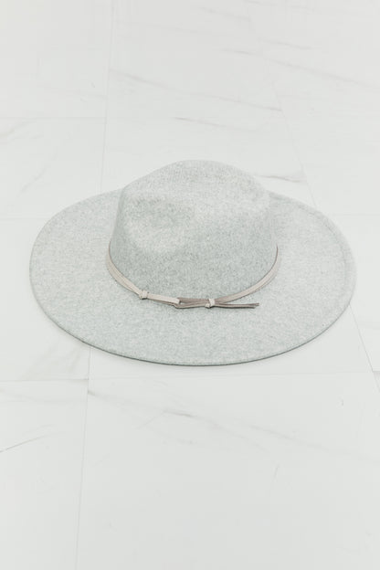 a wide brim Gray felt fedora hat with a leather tie detail on a white background