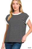 Woman wearing a black and white striped short sleeve top with white trim and blue jeans.
