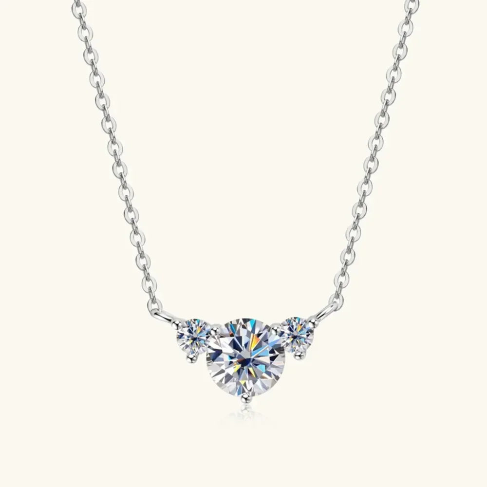 Sterling silver chain necklace with three round clear gemstones, centered on a white background.
