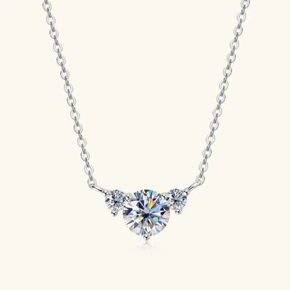 Sterling silver chain necklace with three round clear gemstones, centered on a white background.