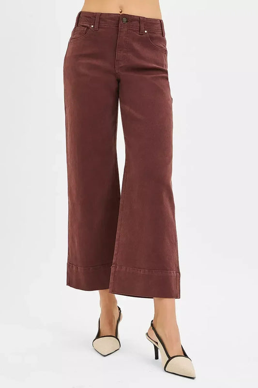 Wide-leg cropped brown pants with high waist, styled with beige slingback heels.