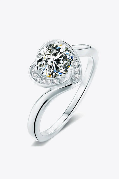 Elegant silver ring with a large round center stone and small accent stones on a modern band
