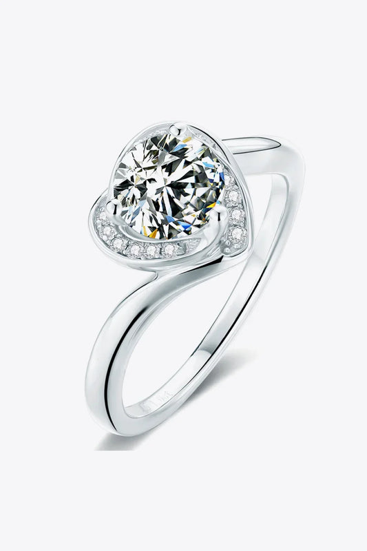 Elegant silver ring with a large round center stone and small accent stones on a modern band