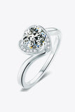 Elegant silver ring with a large round center stone and small accent stones on a modern band
