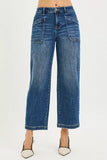 High-waisted wide leg blue jeans with large front pockets, styled with heels