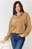 Woman wearing a brown corduroy Long Sleeve Dropped Shoulder Jacket and blue jeans against a white background