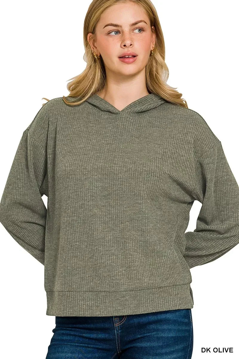 Woman wearing a dark olive ribbed knit hoodie with relaxed fit and long sleeves