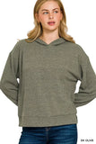 Woman wearing a dark olive ribbed knit hoodie with relaxed fit and long sleeves