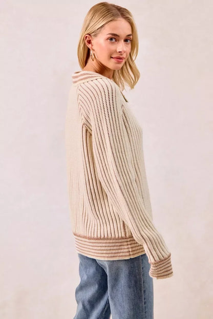 Woman wearing beige ribbed knit sweater with relaxed fit and light wash jeans