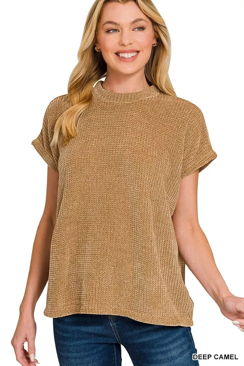 Woman wearing a short sleeve knit top in deep camel color with relaxed fit and crew neckline