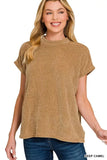 Woman wearing a short sleeve knit top in deep camel color with relaxed fit and crew neckline