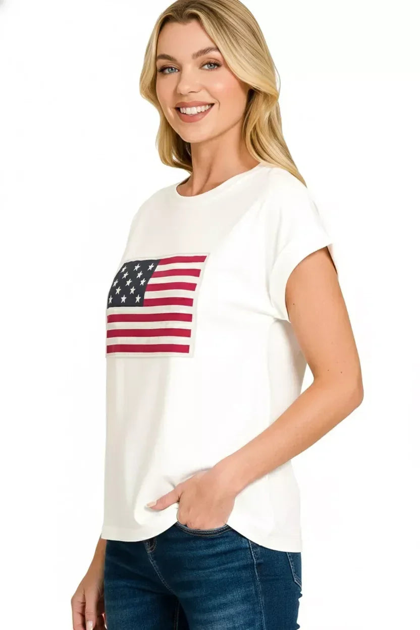 Woman wearing white short sleeve t-shirt with American flag print and blue jeans