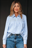 Woman wearing a blue and white striped blouse with smocked detail and blue jeans