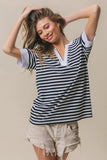 Woman wearing navy and white BiBi Contrast Striped Notched Knit Top with white trim and beige frayed shorts