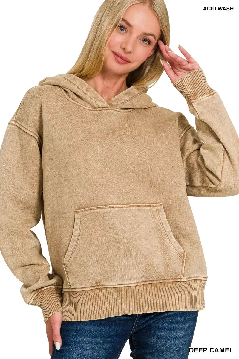 Woman wearing a deep camel acid wash hoodie with kangaroo pocket and relaxed fit.