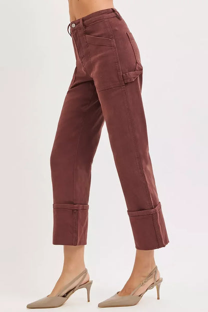 Side view of woman wearing high-waisted, cropped mauve pants with tailored details