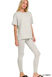 Woman wearing light cement oversized t-shirt and matching leggings set