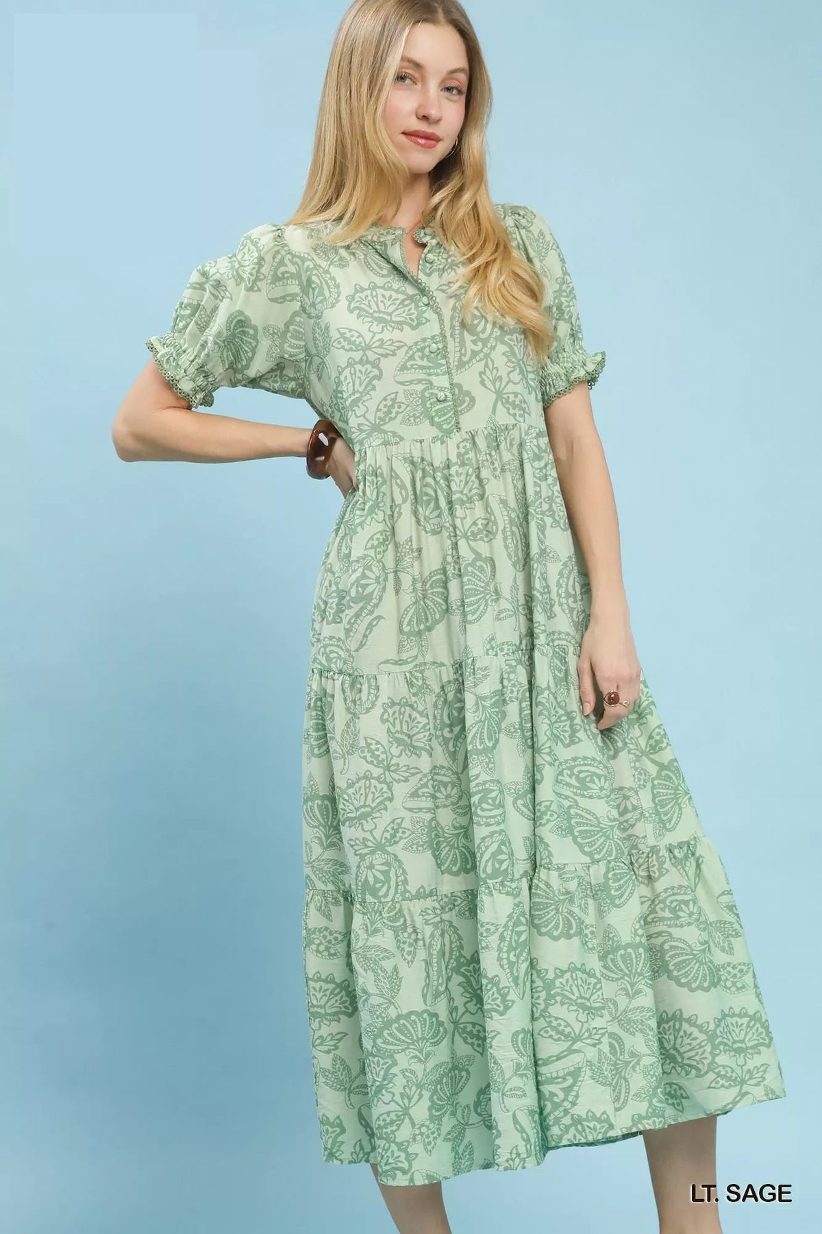 Woman wearing an Umgee Paisley Print Tiered Midi Dress on a blue background 
