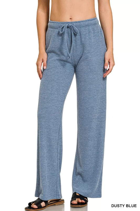 Woman wearing dusty blue ribbed knit wide-leg lounge pants with drawstring waist