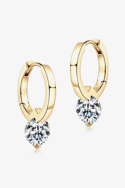 Gold hoop earrings with round clear gemstone pendants on a white background